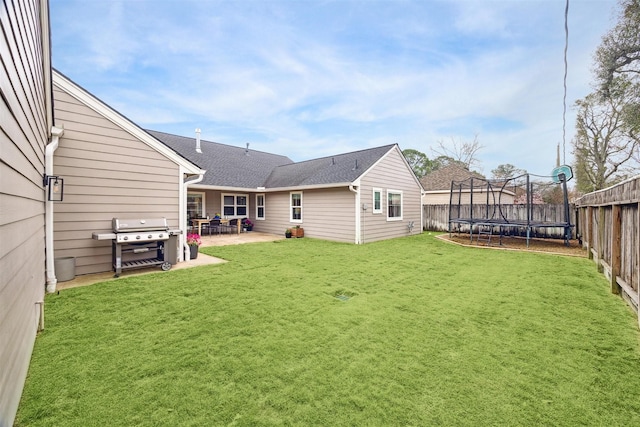 view of yard featuring a trampoline and a patio area