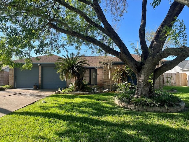 single story home featuring a front lawn and a garage