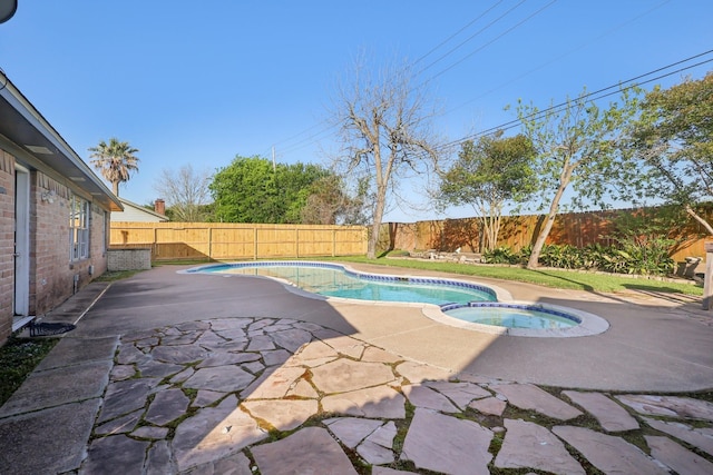 view of pool featuring a patio, a fenced backyard, and a pool with connected hot tub