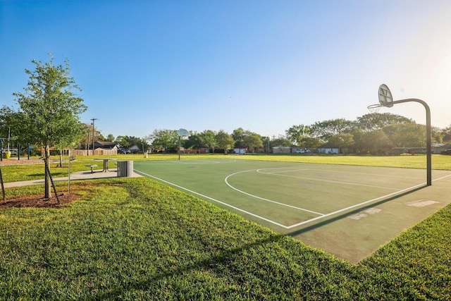 view of basketball court featuring community basketball court and a lawn