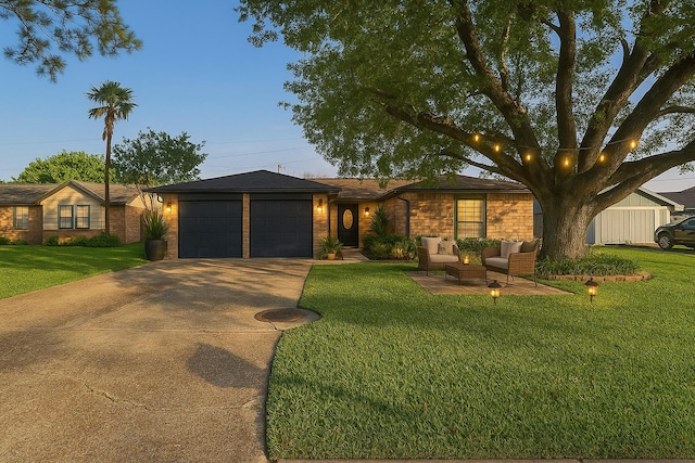 3212 Wavecrest St, League City, TX 77573 - view of front of home featuring an attached garage, concrete driveway, a front yard, an outdoor hangout area, and brick siding