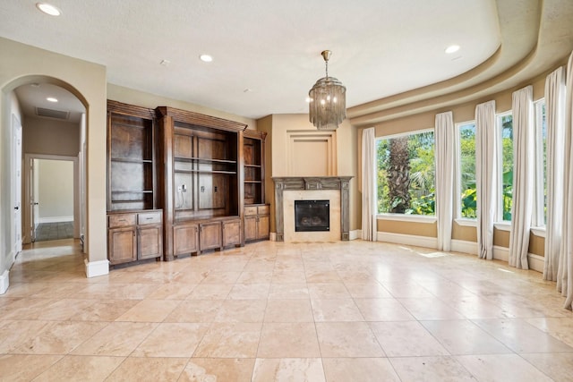 unfurnished living room featuring recessed lighting, visible vents, baseboards, and a high end fireplace