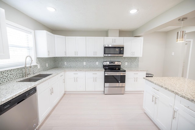 kitchen featuring white cabinetry, sink, and stainless steel appliances