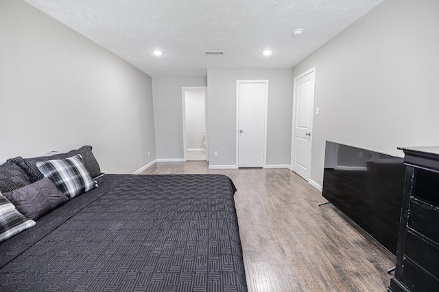 bedroom featuring dark wood-type flooring and a textured ceiling