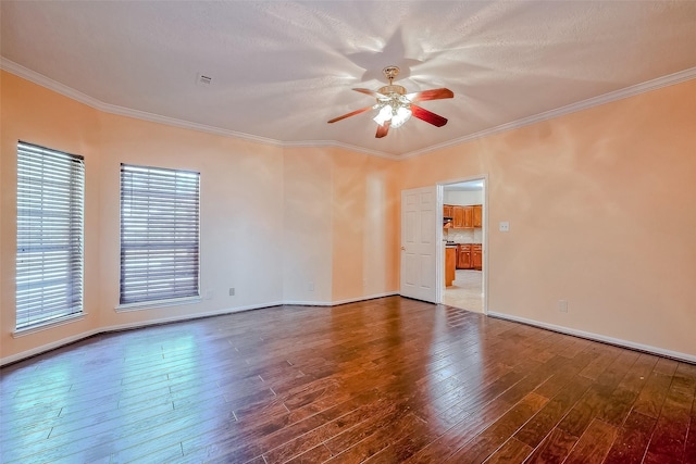 empty room featuring a textured ceiling, ornamental molding, dark hardwood / wood-style floors, and ceiling fan