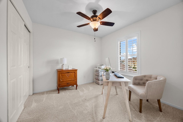 living area featuring light carpet and ceiling fan