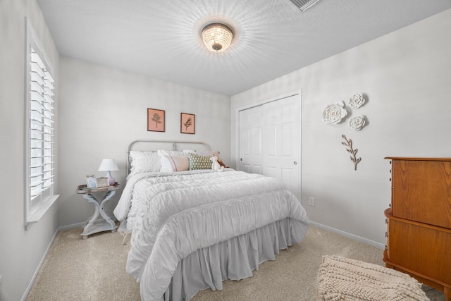 carpeted bedroom with a closet