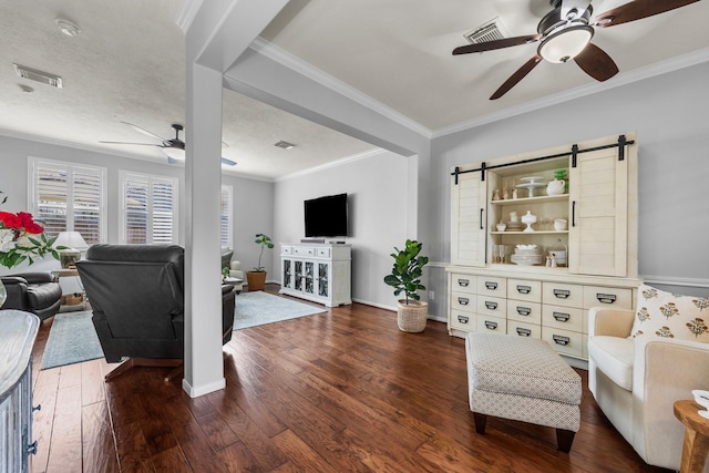 living room featuring ceiling fan, plenty of natural light, crown molding, and dark hardwood / wood-style flooring