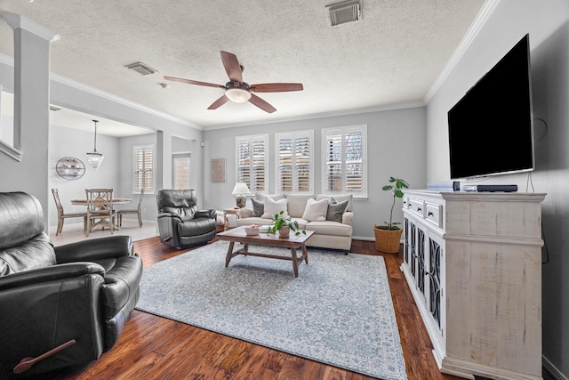 living room featuring a textured ceiling, ceiling fan, crown molding, and dark hardwood / wood-style flooring