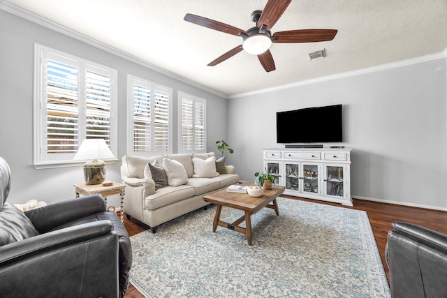 living room with ceiling fan, dark wood-type flooring, and ornamental molding