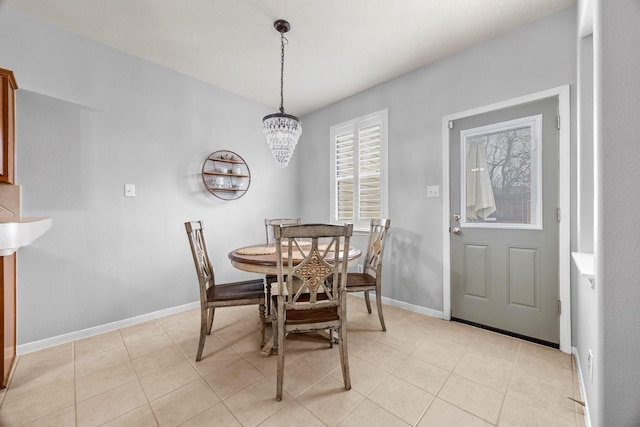 tiled dining area with a chandelier