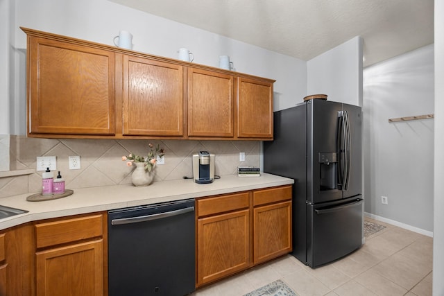 kitchen featuring black appliances, tasteful backsplash, and light tile patterned floors