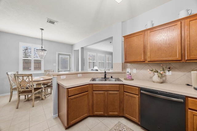 kitchen featuring dishwashing machine, a healthy amount of sunlight, pendant lighting, and sink