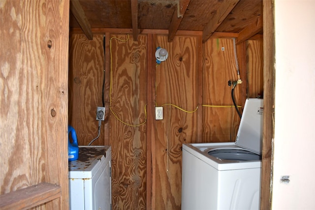 washroom with wood walls and washer / clothes dryer