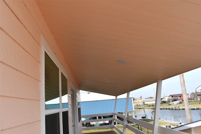 view of patio / terrace with a water view and a balcony