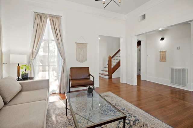 living room featuring visible vents, stairway, ornamental molding, wood finished floors, and baseboards