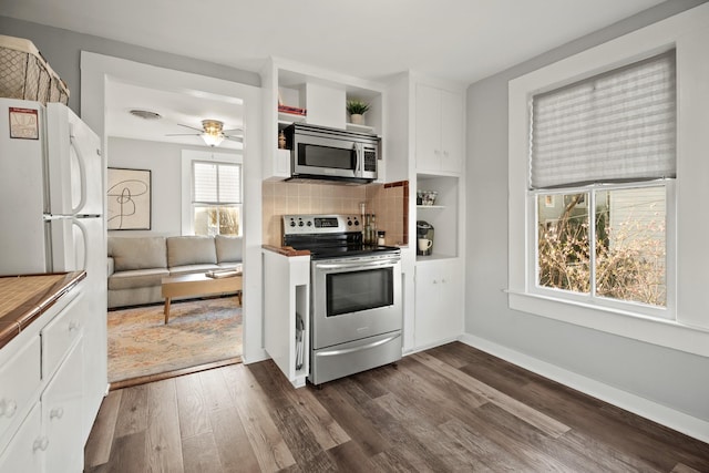 kitchen featuring dark wood-style flooring, white cabinetry, appliances with stainless steel finishes, backsplash, and open shelves