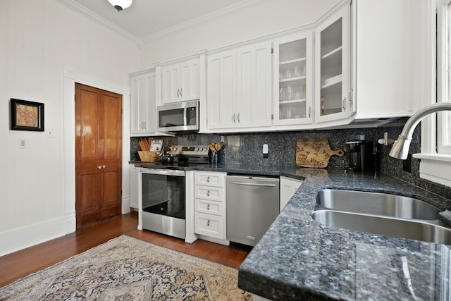 kitchen featuring a sink, white cabinetry, appliances with stainless steel finishes, backsplash, and crown molding