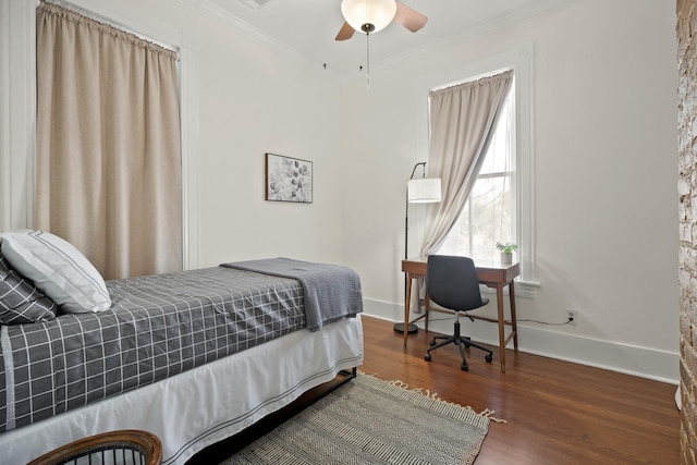 bedroom featuring baseboards, ornamental molding, and wood finished floors