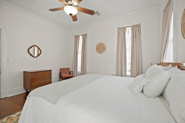 bedroom with ornamental molding, dark wood-style flooring, and visible vents