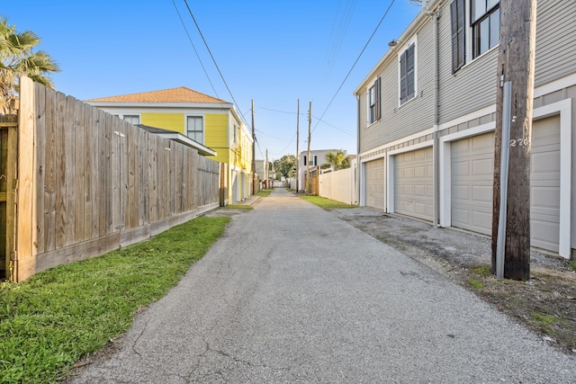 view of road featuring community garages