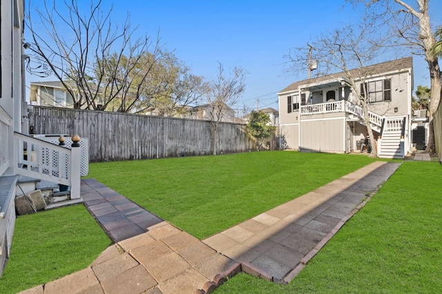 view of yard featuring stairs and a fenced backyard