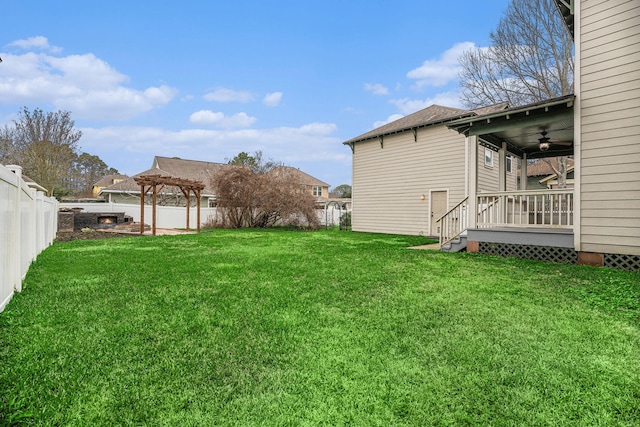 view of yard featuring ceiling fan, a pergola, and a wooden deck