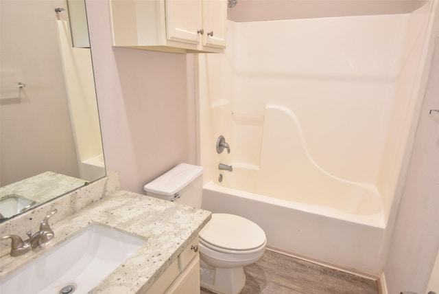 12565 Melville Dr Unit 224, Montgomery, TX 77356 - full bathroom with hardwood / wood-style flooring, vanity, toilet, and washtub / shower combination