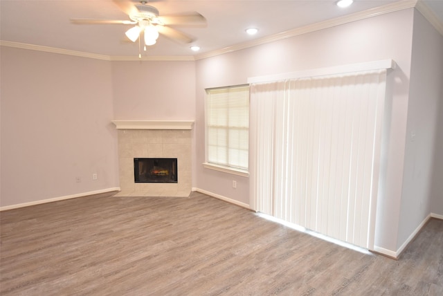 12565 Melville Dr Unit 224, Montgomery, TX 77356 - unfurnished living room with a fireplace, hardwood / wood-style flooring, crown molding, and ceiling fan