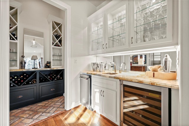 bar with indoor wet bar, wine cooler, brick floor, and a sink