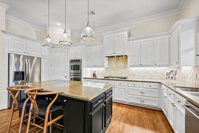 kitchen with stainless steel appliances, visible vents, and white cabinets