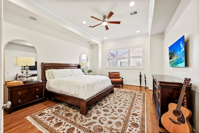 bedroom featuring recessed lighting, visible vents, wood finished floors, and ornamental molding