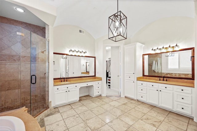 bathroom featuring a sink, visible vents, two vanities, and a stall shower