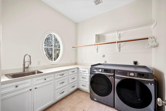 laundry area with light tile patterned floors, visible vents, cabinet space, a sink, and independent washer and dryer