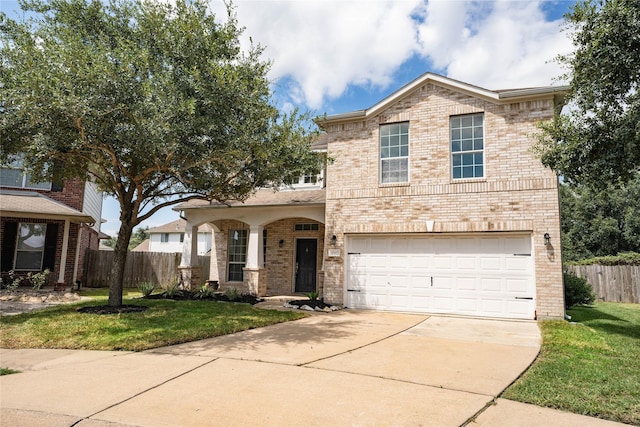 view of front of house featuring a front lawn and a garage