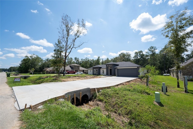 single story home featuring a front lawn and a garage