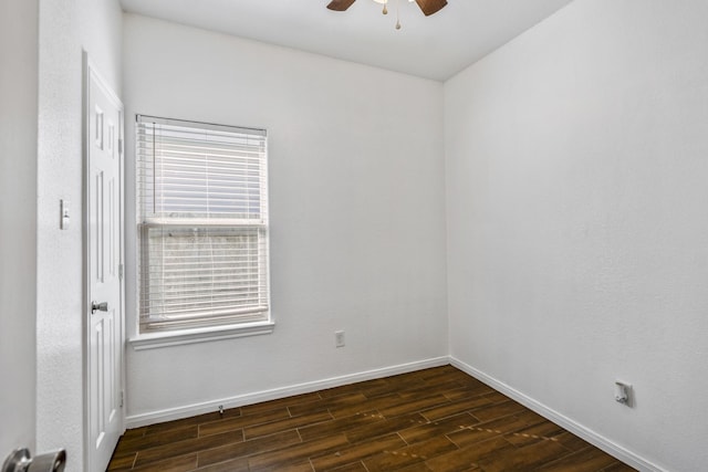 empty room with dark hardwood / wood-style floors and ceiling fan