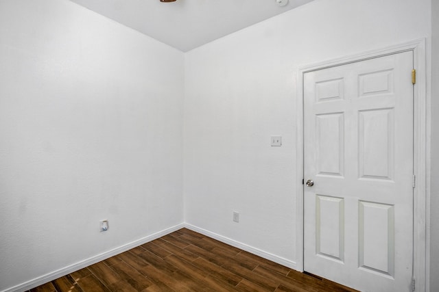 unfurnished room with dark hardwood / wood-style flooring