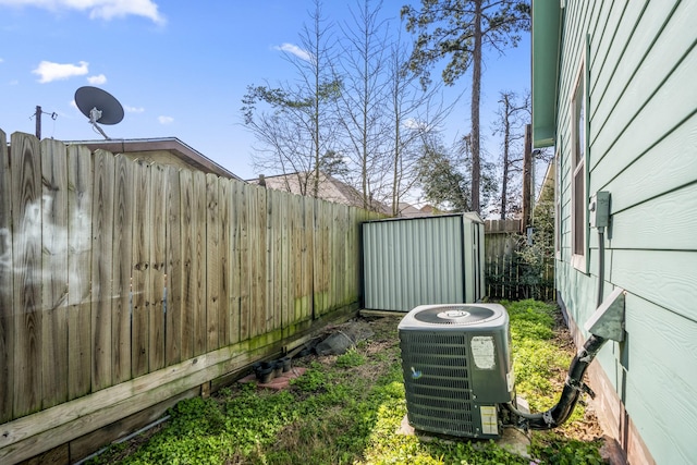 view of yard featuring a storage unit and cooling unit