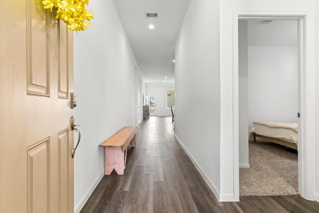 hall with baseboards, visible vents, dark wood finished floors, and recessed lighting