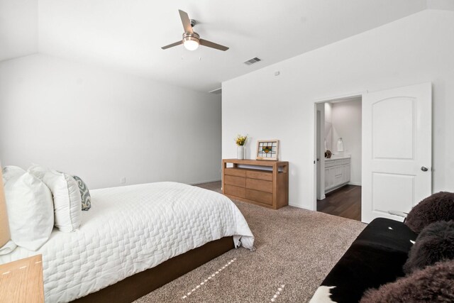 carpeted bedroom with lofted ceiling, ensuite bath, visible vents, and a ceiling fan