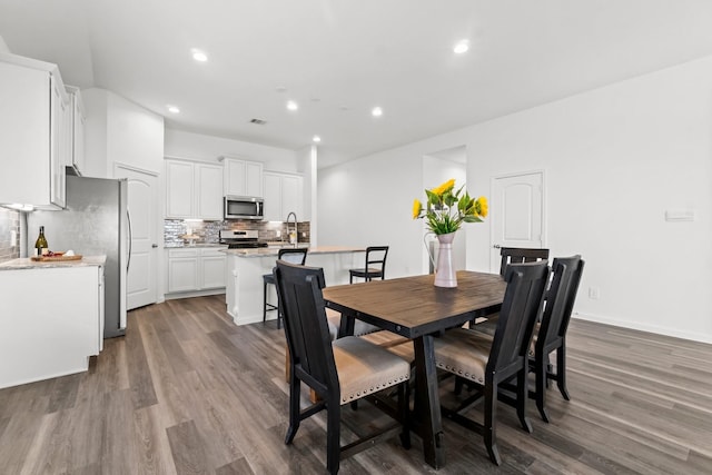 dining room with visible vents, wood finished floors, and recessed lighting