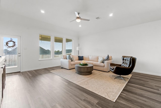 living room with recessed lighting, visible vents, baseboards, and wood finished floors