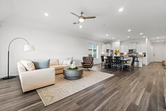 living room featuring recessed lighting, dark wood-style flooring, ceiling fan, and baseboards