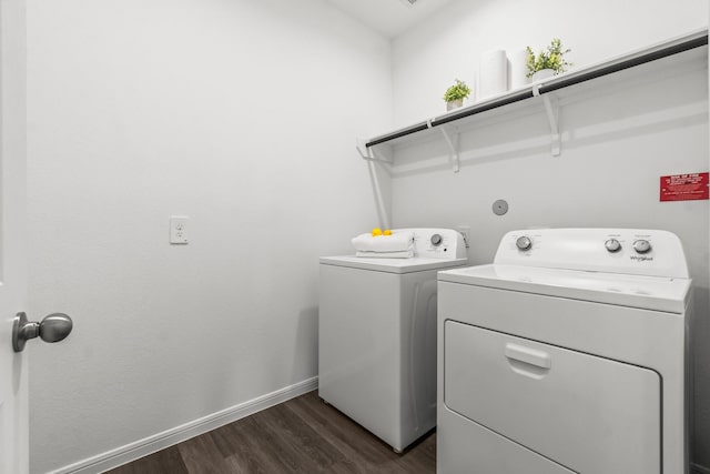 laundry room with dark wood-type flooring, laundry area, baseboards, and washing machine and clothes dryer