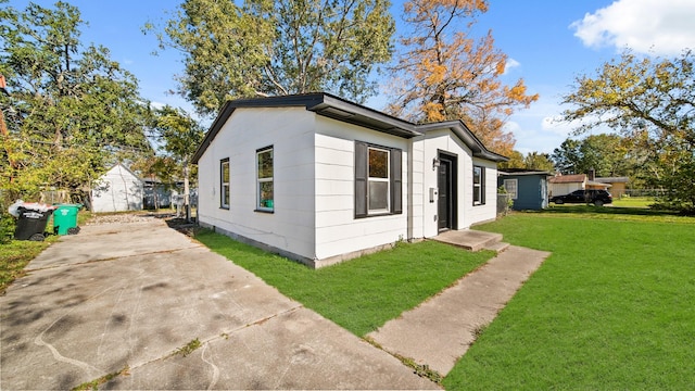 view of side of home with a lawn