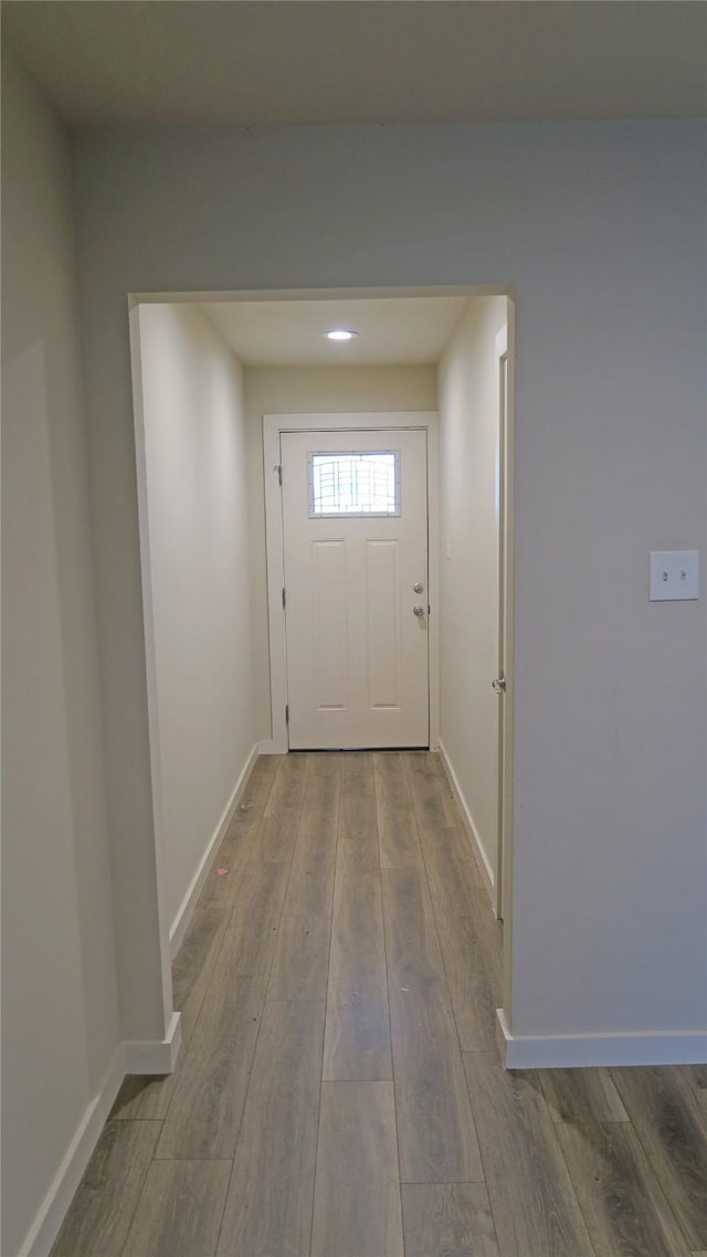 entryway with wood finished floors and baseboards