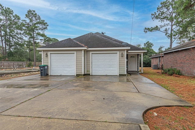 view of front facade featuring central AC and a garage