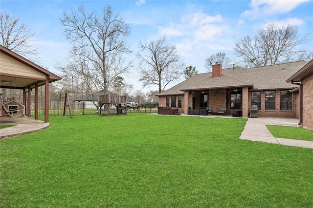 view of yard with a patio area and a hot tub