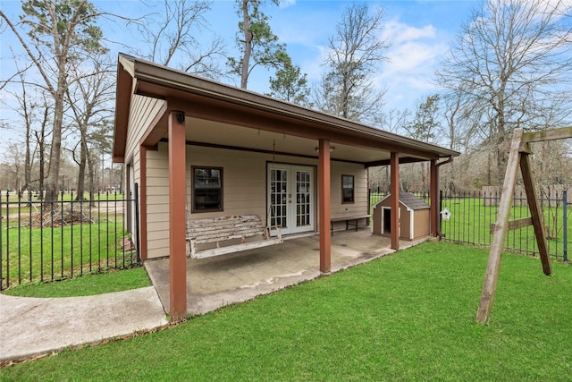 rear view of house featuring french doors, a yard, and a patio area